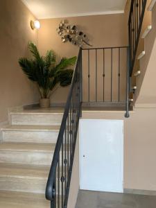 a staircase in a house with a potted plant at Locanda il Deserto in Livorno