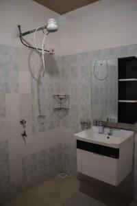 a bathroom with a sink and a shower at Reens Vacation Rentals in Nakuru