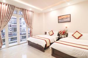 Giường trong phòng chung tại Mai Hoang Da Lat Hotel