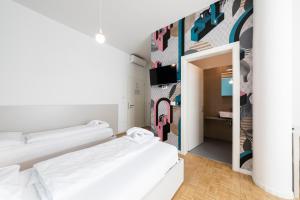 a bedroom with two beds and a mural at Stay COOPER l Capitol Rooms in Bolzano