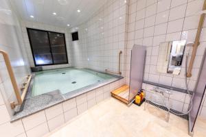 a bathroom with a swimming pool in a room at Atami Onsen Yamaki Ryokan in Atami +24 photos