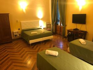 Giường trong phòng chung tại Hotel Giglio