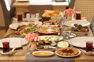 a table topped with plates of food at Hatton Suites Hotel Esenboga in Ankara
