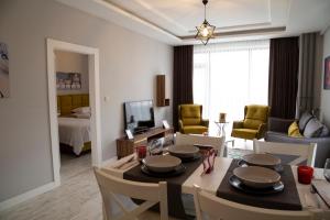 a living room filled with furniture and a table at Hatton Suites Hotel Esenboga in Ankara