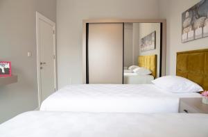 a bedroom with a white bed and white walls at Hatton Suites Hotel Esenboga in Ankara