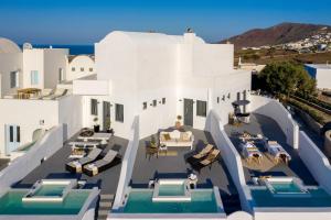 an aerial view of a villa with a swimming pool at Santolia Art Suites in Oia