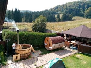 einen Hinterhof mit einem Whirlpool und einem Pavillon in der Unterkunft Poiana Cristian in Poiana Brașov