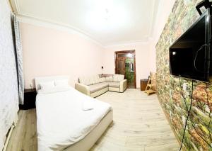 ShuyaにあるАпартаменты 42 мのベッド、テレビ、ソファが備わる客室です。