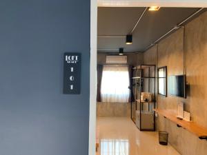 a hallway of a room with a television and a room with a unintention at Loft Space Hotel in Ranong
