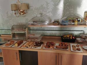 a counter with many different types of donuts on at Hotel Alfonso VIII De Cuenca in Cuenca