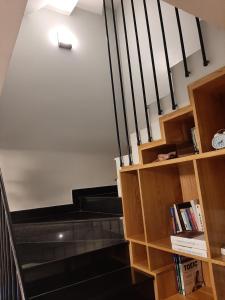 a staircase with a book shelf and a stair case at Thom's Homestay in Vung Tau