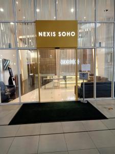 een lobby met een nieuwbord in een gebouw bij 3 Room SUNWAY NEXIS KOTA DAMANSARA 5min MRT 7min Tropicana mall in Petaling Jaya