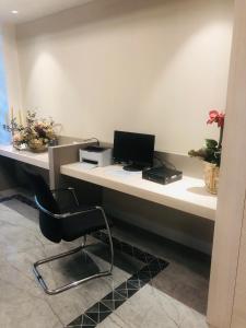 an office with a desk with a computer and a chair at Hotel Olimpia in Imola