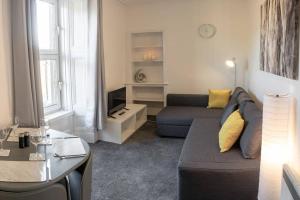 ein Wohnzimmer mit einem Sofa und einem Tisch in der Unterkunft ☆Modern Flat, Close to University and City Centre☆ in Dundee