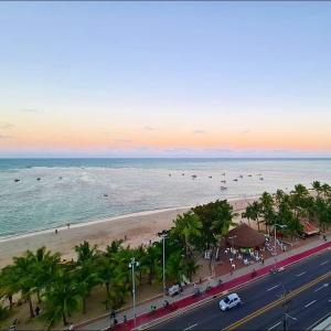 a view of a beach with palm trees and the ocean at Apto ALTO PADRÃO em Maceió in Maceió