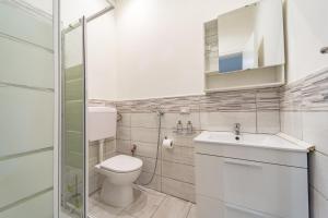 a bathroom with a toilet and a sink and a shower at Naranji House Blue - Relax in Altavilla Milicia