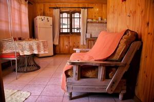 a kitchen with a bed and a table and a refrigerator at FRIDA in Puerto Iguazú