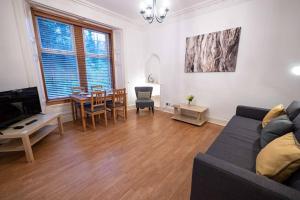 a living room with a couch and a table at ☆ Spacious 2 Bed flat, Close to University ☆ in Dundee