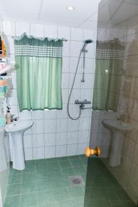 ein Bad mit einer Dusche und einem Waschbecken in der Unterkunft Mere kodumajutus in Kärdla