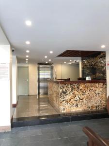 a lobby with a stone counter in a building at Moc Hoang Hotel in Hanoi