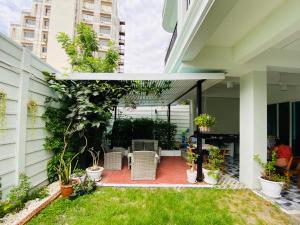 a patio with chairs and plants on a building at TEAK VILLA in Bangna
