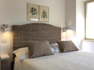 a bedroom with a large bed with two pillows at La Loggia in Chiavenna