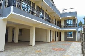 Executive Two & Three Bedroom Suites في ناكورو: مبنى به درج وبلكونه