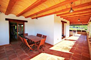 a patio with a wooden table and chairs at Finca Argudo - private pool villa in Moraira in Moraira