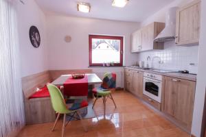 a kitchen with a table and chairs in it at Timber Apartment in Bohinj