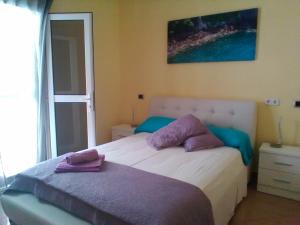 a bedroom with a bed with towels on it at B&B Paraiso del Sol in Maspalomas