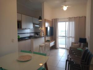 a kitchen and dining room with a table and chairs at Ubatuba - Praia das Toninhas in Ubatuba