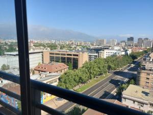 a view of a city from a window at Departamento Metro Parque Bustamante in Santiago
