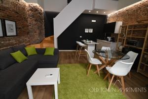 a living room with a couch and a table at Old Town Apartments Catania in Catania