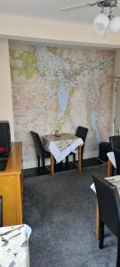 a room with a table and a map on the wall at Babbling Brook Guesthouse in Keswick