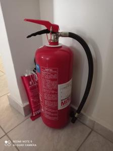 a red fire hydrant sitting next to a wall at CityHome2 in Larisa