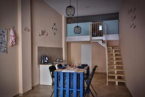 a kitchen with a table and chairs and a staircase at The Best of Me in Naples