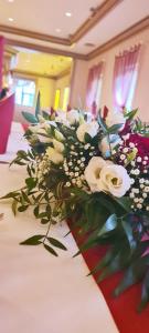 a bouquet of white flowers on a table at Nordischer Hof in Krakow am See