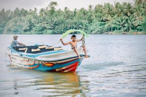 people on a boat in the water at Waterland in Negombo