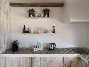 a kitchen with white walls and wooden cabinets at Snug Houseguests in Lisbon