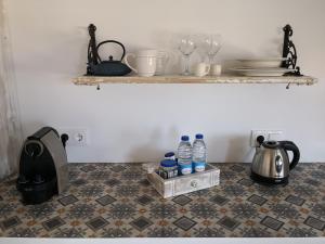 a kitchen counter with bottles of water on a tile floor at Snug Houseguests in Lisbon
