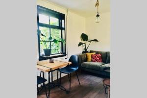 a living room with a couch and a table at Studio Mika met whirlpool! in Julianadorp