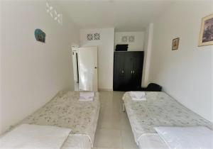 Giường trong phòng chung tại Villa Claudia - apartamento cómodo y tranquilo