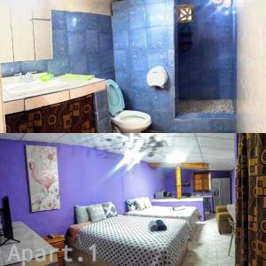 łazienka z 2 łóżkami, umywalką i toaletą w obiekcie Windmill Hostal w mieście Valle de Anton