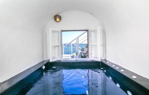 The swimming pool at or near Luxury Santorini Villa Aurora Grace Villa Indoor Plunge Pool Caldera View 1 BDR Oia