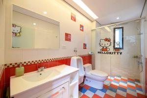 a bathroom with a sink and a toilet and a mirror at 澎湖遛一遛旅店 in Magong