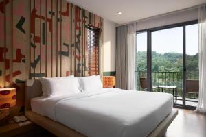 Postel nebo postele na pokoji v ubytování The Peri Hotel Khao Yai