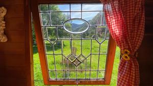 a window with a view of a field of grass at Alpacas Off Grid - House Truck in Takaka