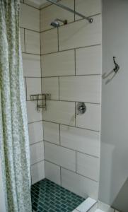 a bathroom with a shower with a shower curtain at Biki Plek 2 in Kimberley
