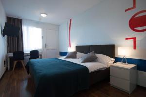 Ένα ή περισσότερα κρεβάτια σε δωμάτιο στο Hotel Bodensee-Arena