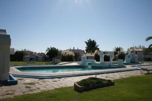a swimming pool in the middle of a yard at Villa Pedras del Rey in Luz de Tavira +3 photos